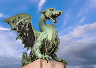 A sculpture of a green dragon on Dragon Bridge, in Ljubljana, Slovenia